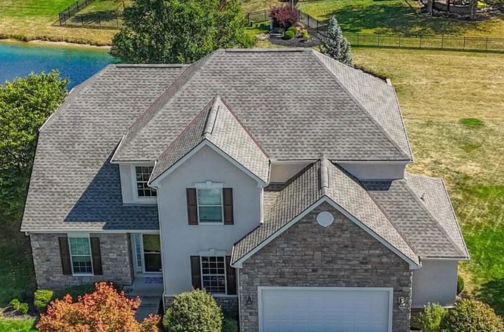 A Surge Exteriors professional installing high-quality roofing materials on a home in Quincy, IL, ensuring strength and style.