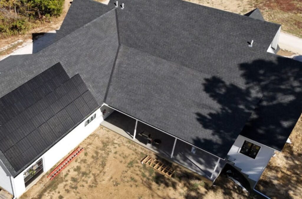 A Surge Exteriors expert securing roofing materials during a roof installation in Quincy, IL, showcasing precision and quality.