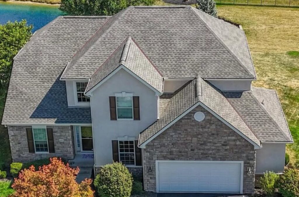 A Surge Exteriors employee providing expert roof repair services in Kirksville, MO, using professional tools for high-quality roof restoration.