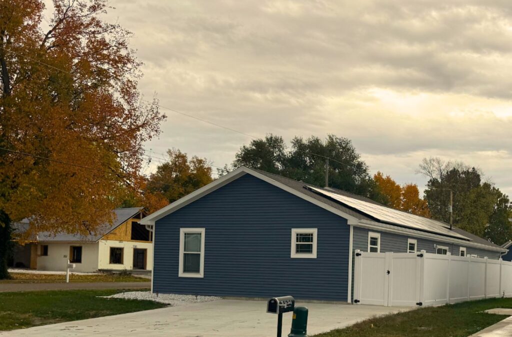 A Surge Exteriors roofing expert working in Kirksville, MO, demonstrating precise workmanship and dependable service on a metal roofing project. Metal Roofing near me.