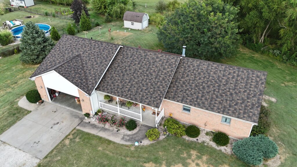 A Surge Exteriors professional working on metal roofing in Quincy, IL, illustrating efficiency and value through local expertise.