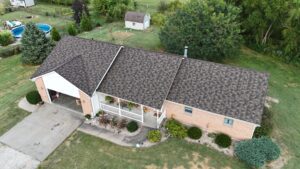 A Surge Exteriors professional working on metal roofing in Quincy, IL, illustrating efficiency and value through local expertise.